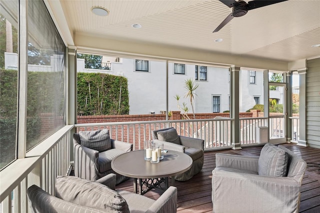 sunroom featuring ceiling fan and wooden ceiling