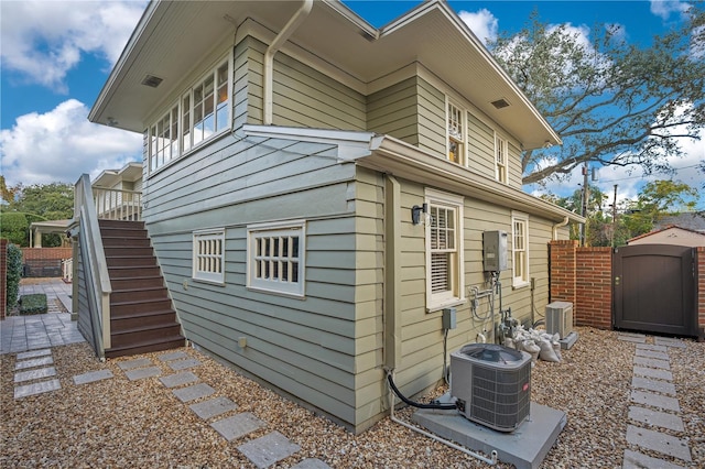 view of side of home featuring central AC