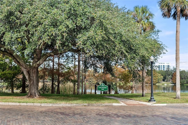 surrounding community with a lawn and a water view