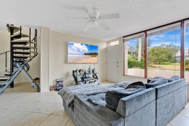 tiled bedroom featuring ceiling fan and a textured ceiling