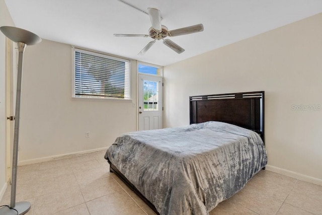 tiled bedroom featuring ceiling fan