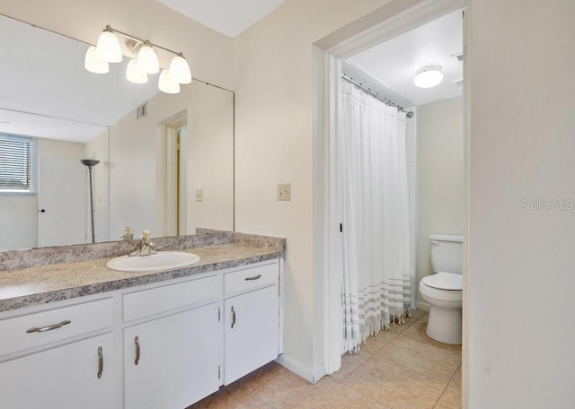 bathroom featuring tile patterned flooring, vanity, toilet, and a shower with curtain