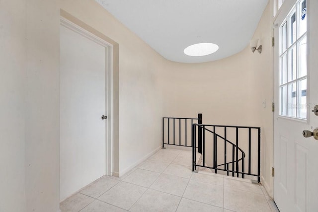 hall with light tile patterned floors