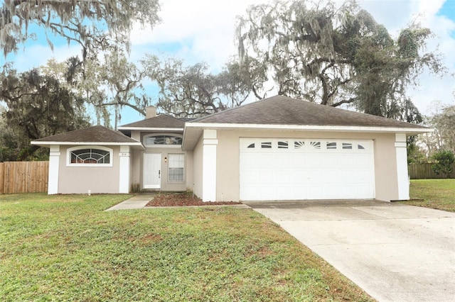 view of front of house with a garage and a front yard