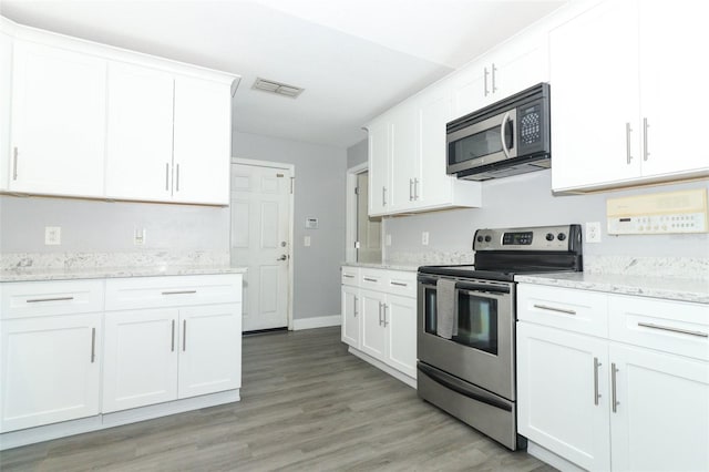 kitchen featuring white cabinets, electric range, light hardwood / wood-style floors, and light stone counters