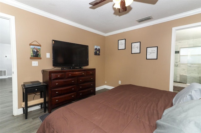 bedroom featuring ensuite bath, ornamental molding, a textured ceiling, ceiling fan, and hardwood / wood-style flooring