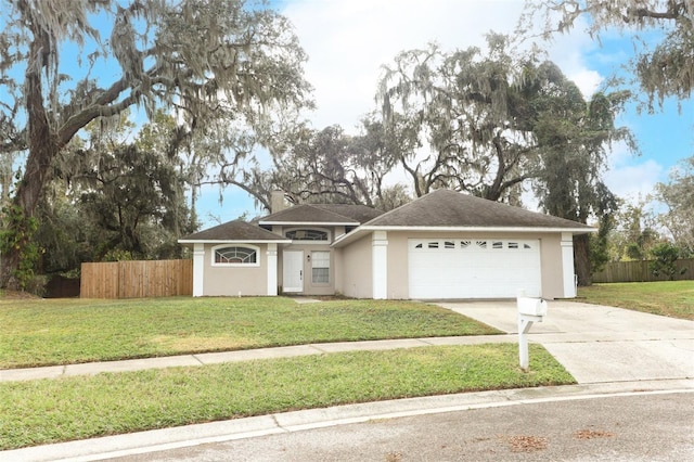 single story home featuring a garage and a front lawn