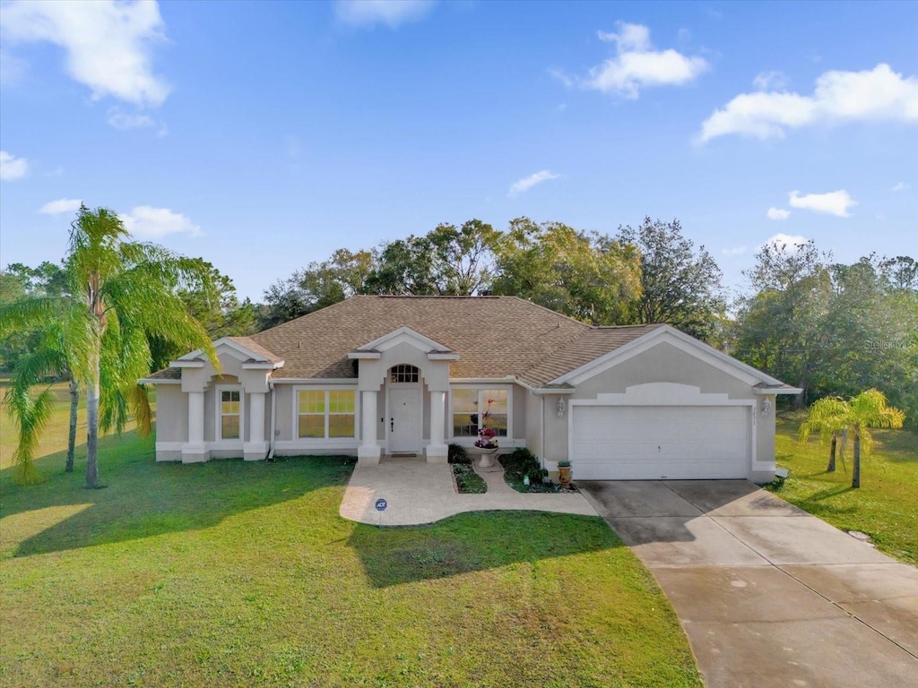 ranch-style house featuring a front yard and a garage