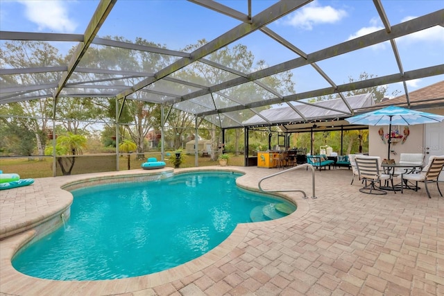 view of pool with a patio and a lanai