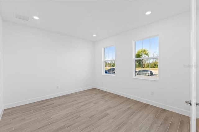 spare room with light wood-type flooring