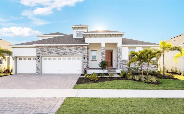 prairie-style home with a garage and a front yard