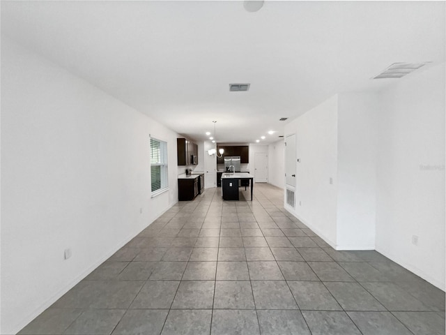 interior space featuring tile patterned floors and a notable chandelier