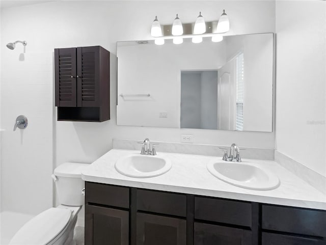 bathroom featuring a shower, vanity, and toilet