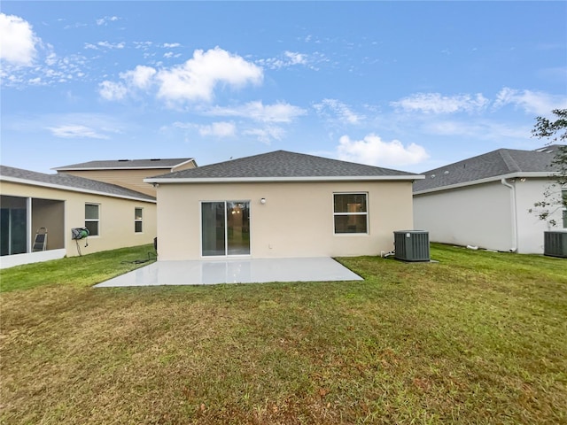 back of house featuring a lawn, cooling unit, and a patio