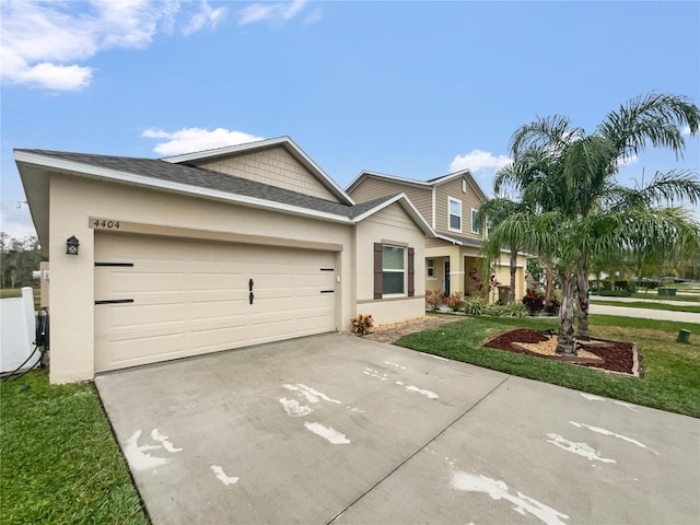 view of front facade with a garage and a front lawn