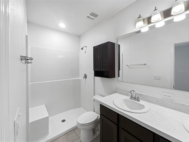 bathroom with tile patterned flooring, a shower, vanity, and toilet