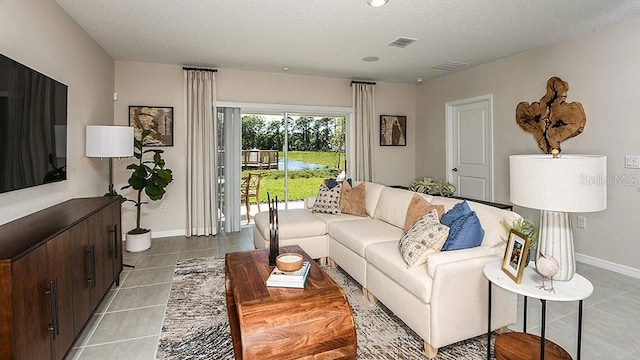 living room featuring light tile patterned floors and a textured ceiling