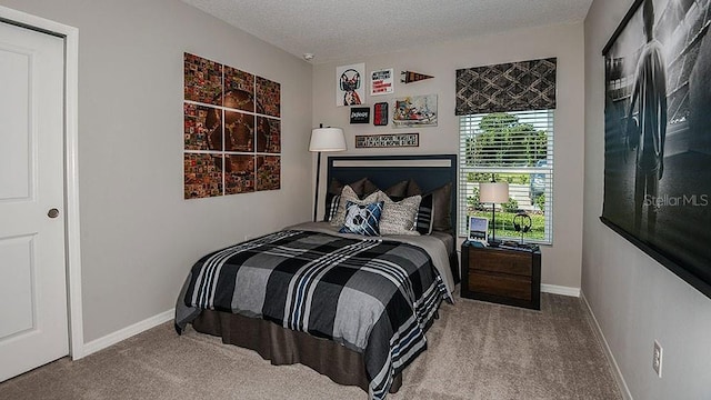 carpeted bedroom featuring a textured ceiling