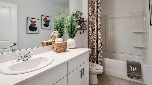 full bathroom with vanity, shower / tub combo, and toilet