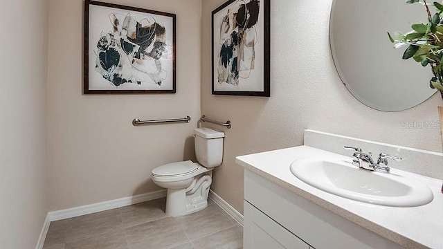 bathroom with tile patterned floors, vanity, and toilet