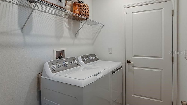 clothes washing area featuring washer and dryer