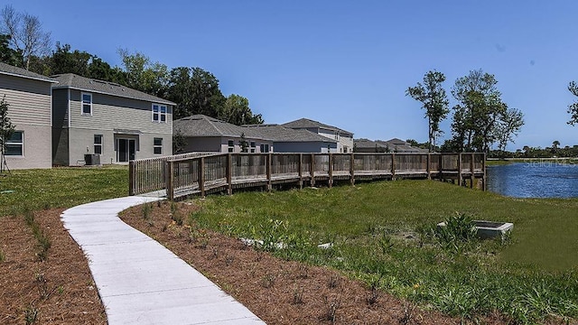 view of yard with a water view and central AC