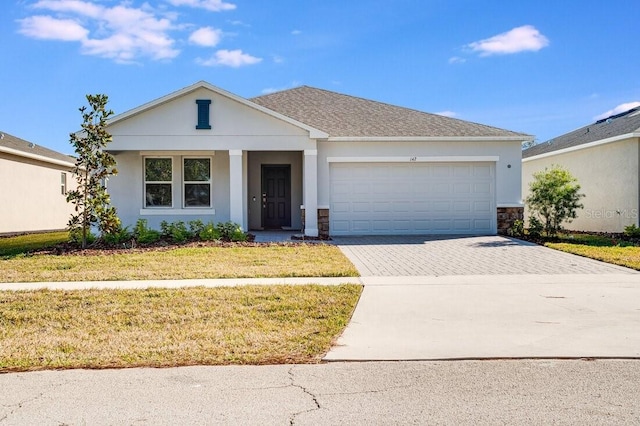 view of front of home with a garage and a front lawn