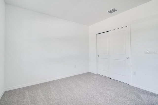 unfurnished bedroom featuring a closet and carpet