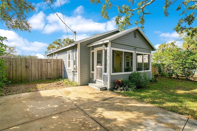 back of house featuring a yard and a patio