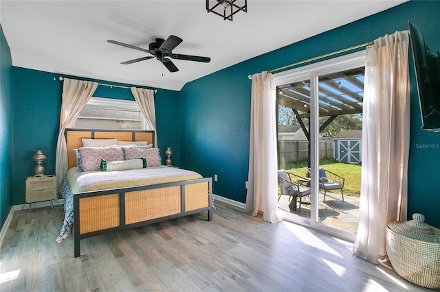 bedroom featuring hardwood / wood-style floors, ceiling fan, and access to exterior