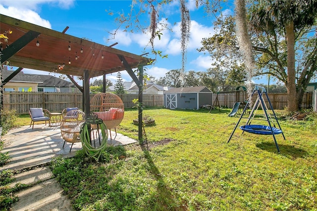 view of yard featuring a playground, a patio, and a shed