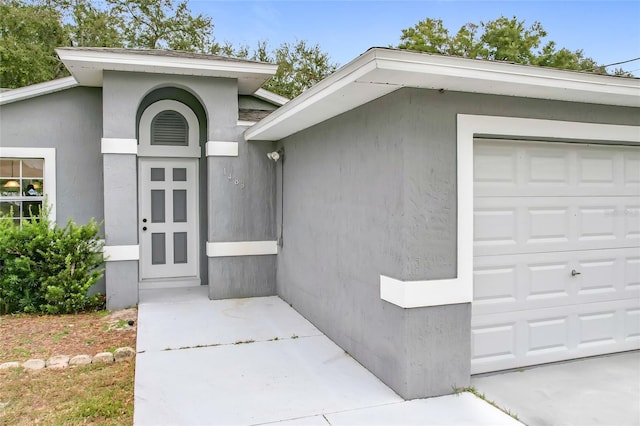 doorway to property featuring a garage