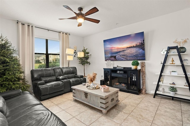 living room with ceiling fan and light tile patterned floors