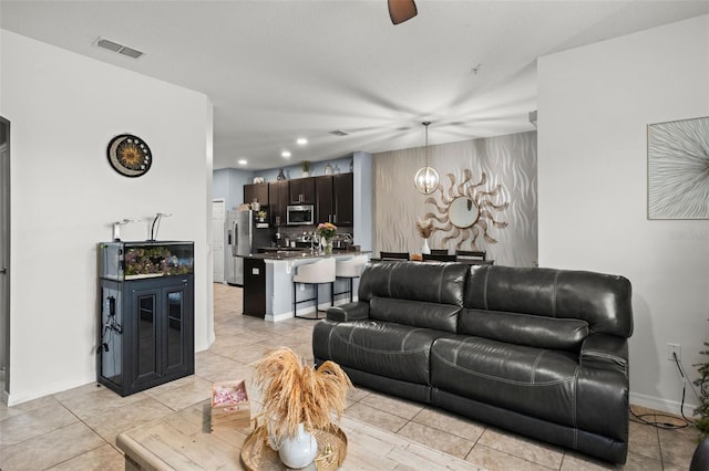 tiled living room with ceiling fan