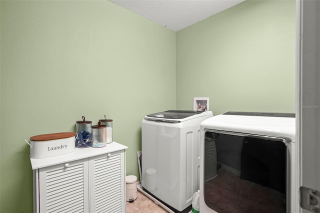 laundry area featuring independent washer and dryer and a textured ceiling