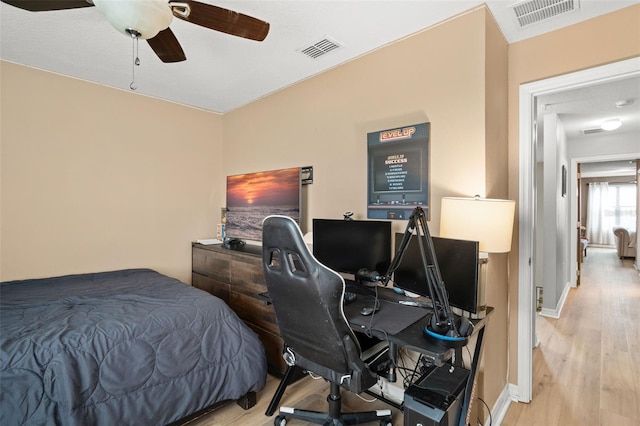 bedroom with light hardwood / wood-style floors and ceiling fan