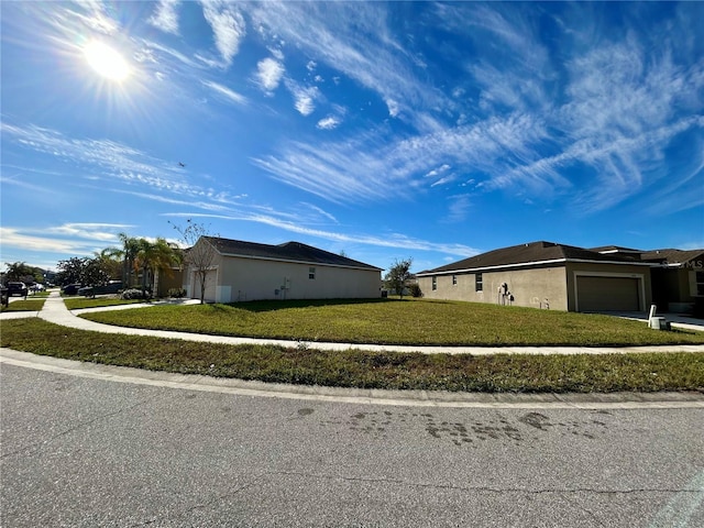 view of side of home featuring a lawn and a garage