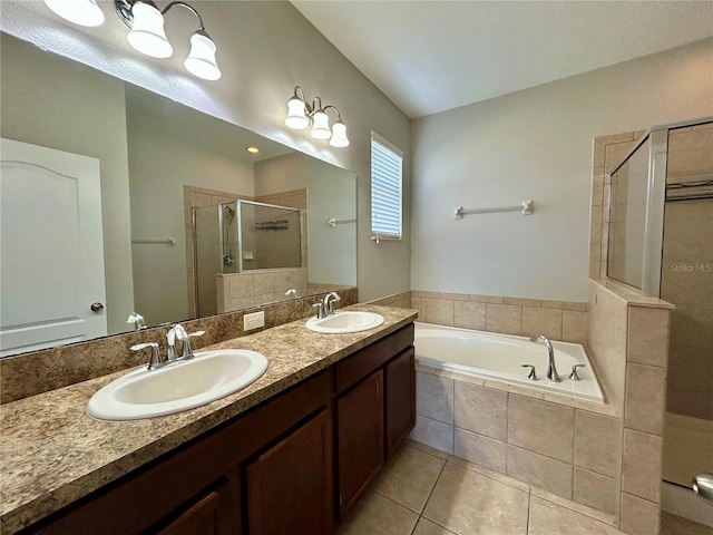 bathroom with plus walk in shower, vanity, and tile patterned floors