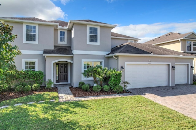 front of property with a front yard and a garage