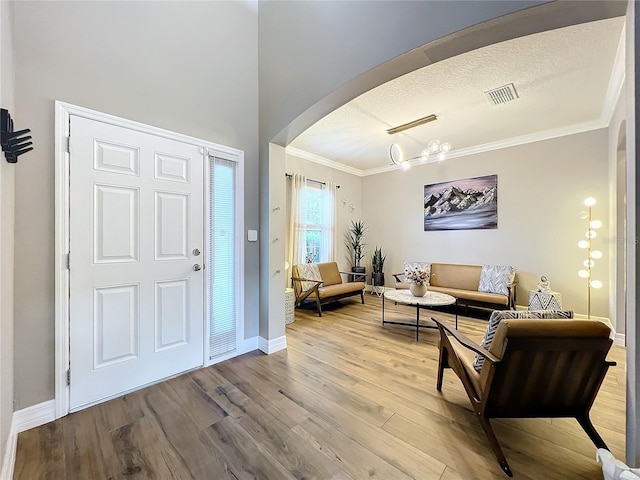 foyer featuring hardwood / wood-style floors and ornamental molding