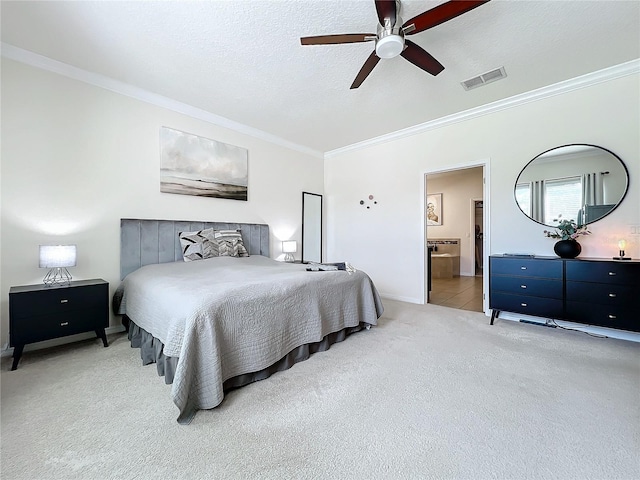 carpeted bedroom with a textured ceiling, ceiling fan, crown molding, and connected bathroom