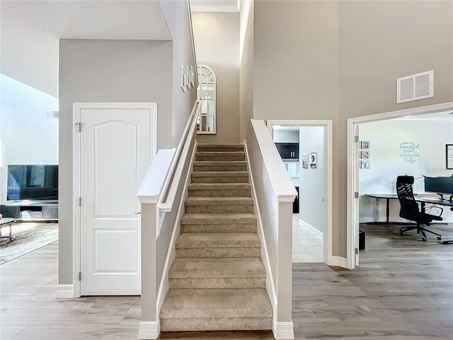 stairway with hardwood / wood-style floors