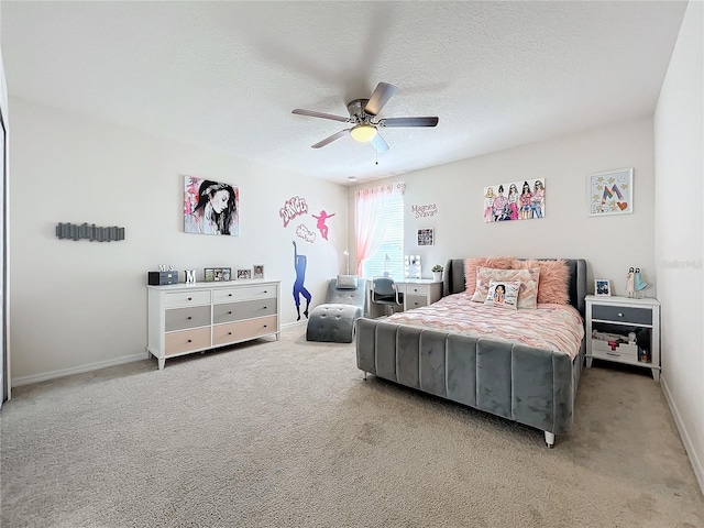 carpeted bedroom featuring ceiling fan and a textured ceiling