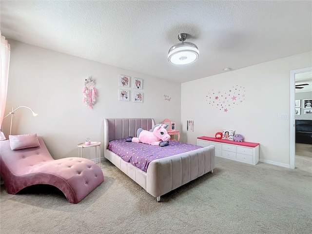 bedroom with carpet floors and a textured ceiling