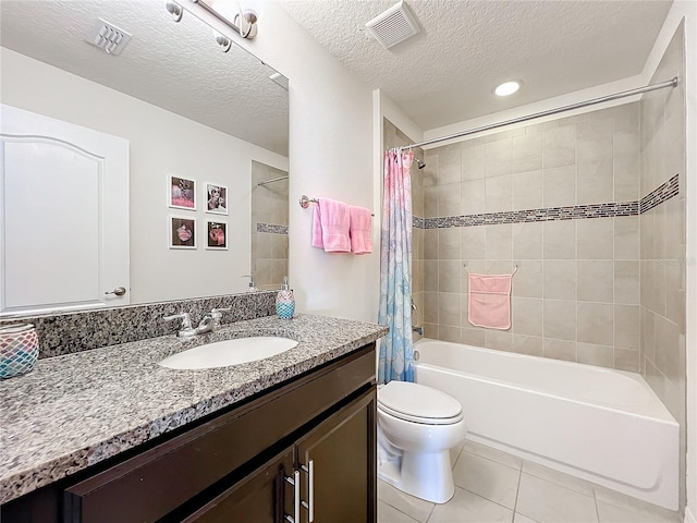 full bathroom featuring vanity, tile patterned flooring, toilet, a textured ceiling, and shower / tub combo