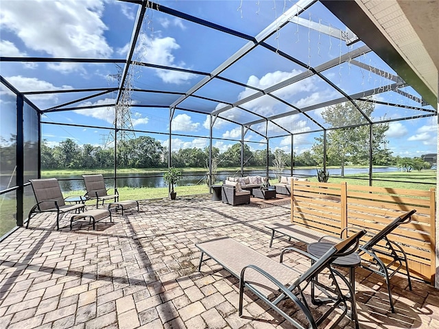 view of patio / terrace with an outdoor hangout area, a water view, and glass enclosure