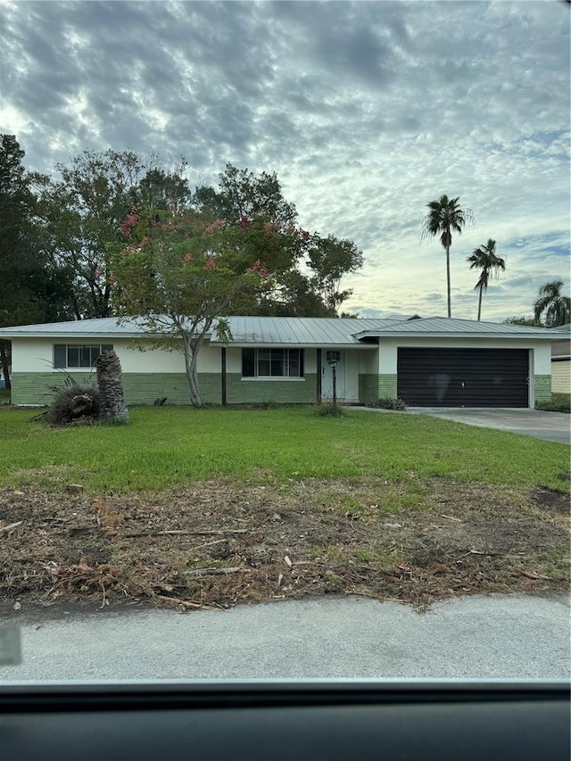 ranch-style home with a front yard and a garage