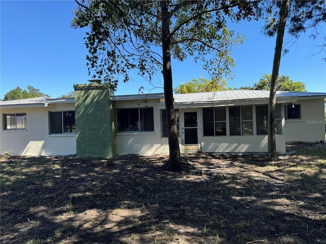 back of property featuring a sunroom