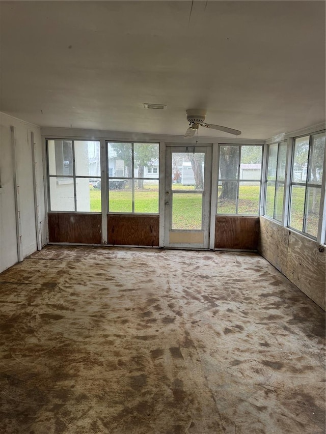 unfurnished sunroom with ceiling fan