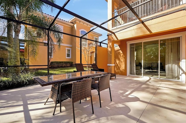 view of patio / terrace with a lanai and a balcony